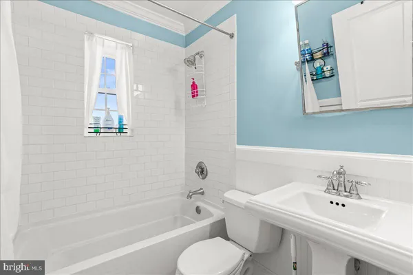 a bathroom with a sink toilet and tub