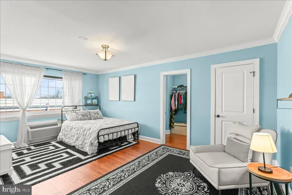 a bedroom with furniture and a lamp