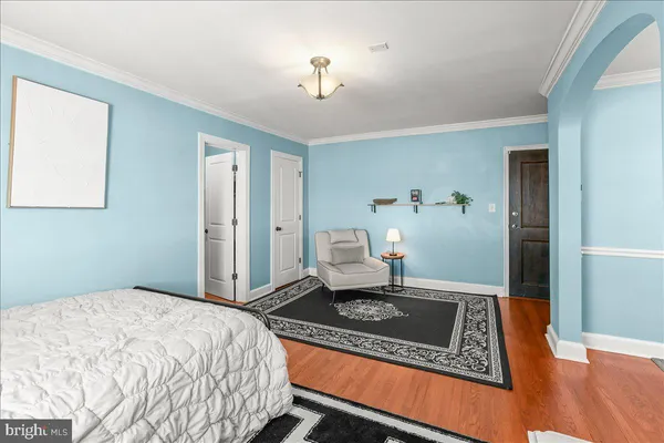 a bedroom with a rug and a sink