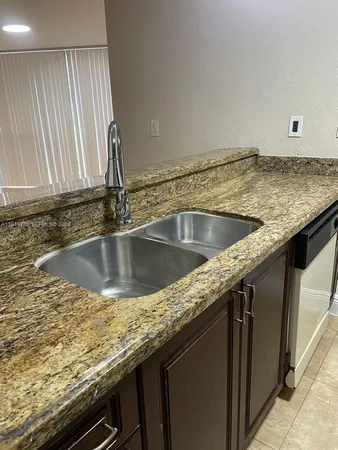 a view of a kitchen counter top a sink and dishwasher