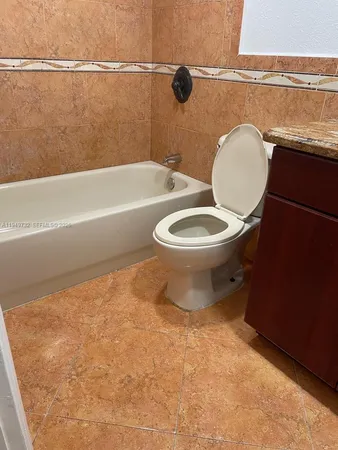 a bathroom with a toilet a sink and bathtub