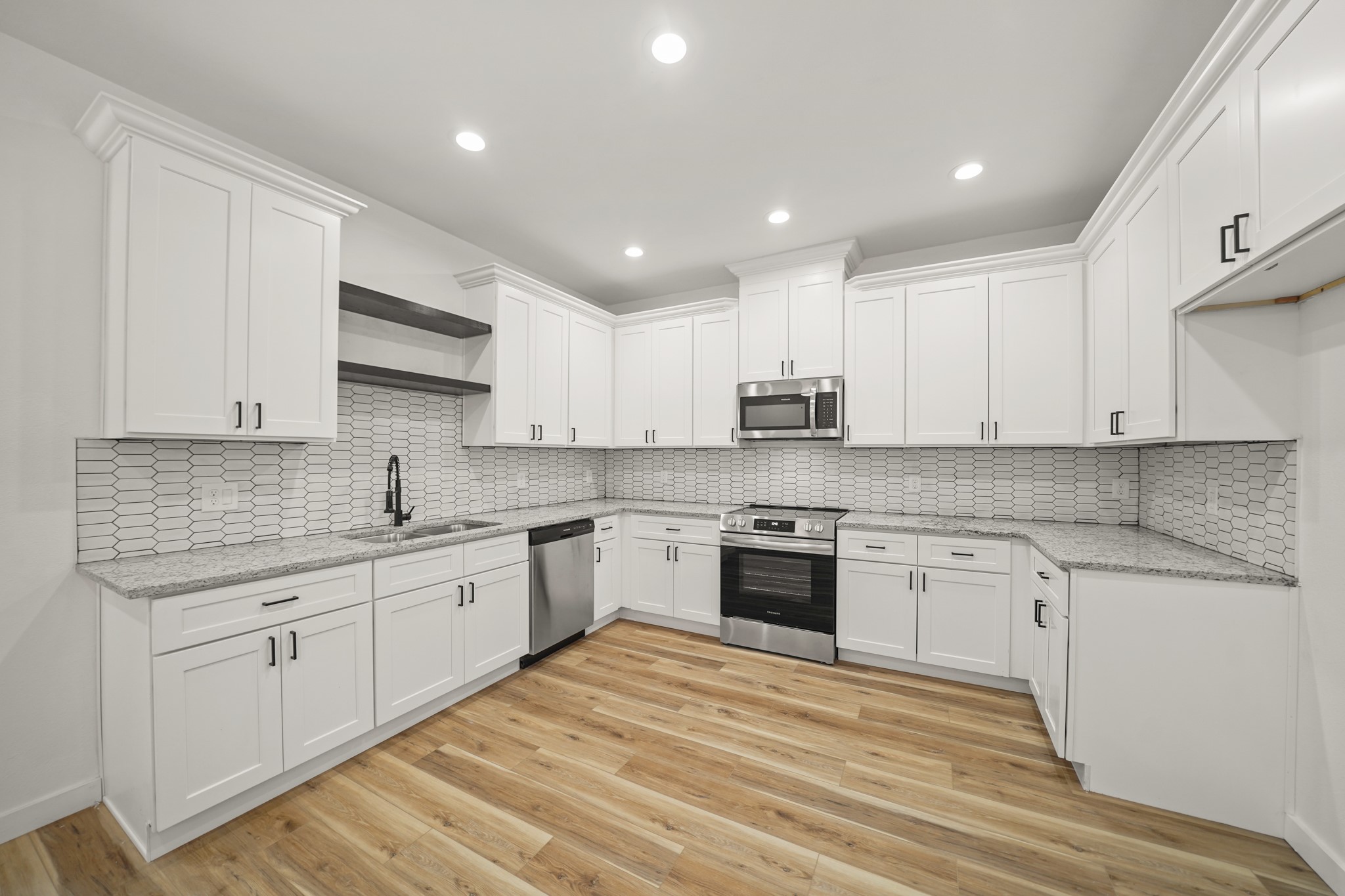 6206 Lyndhurst Drive, Unit AB Houston, TX 77087 - Photo 1 of 14 a large kitchen with granite countertop a stove top oven a sink a counter space and cabinets