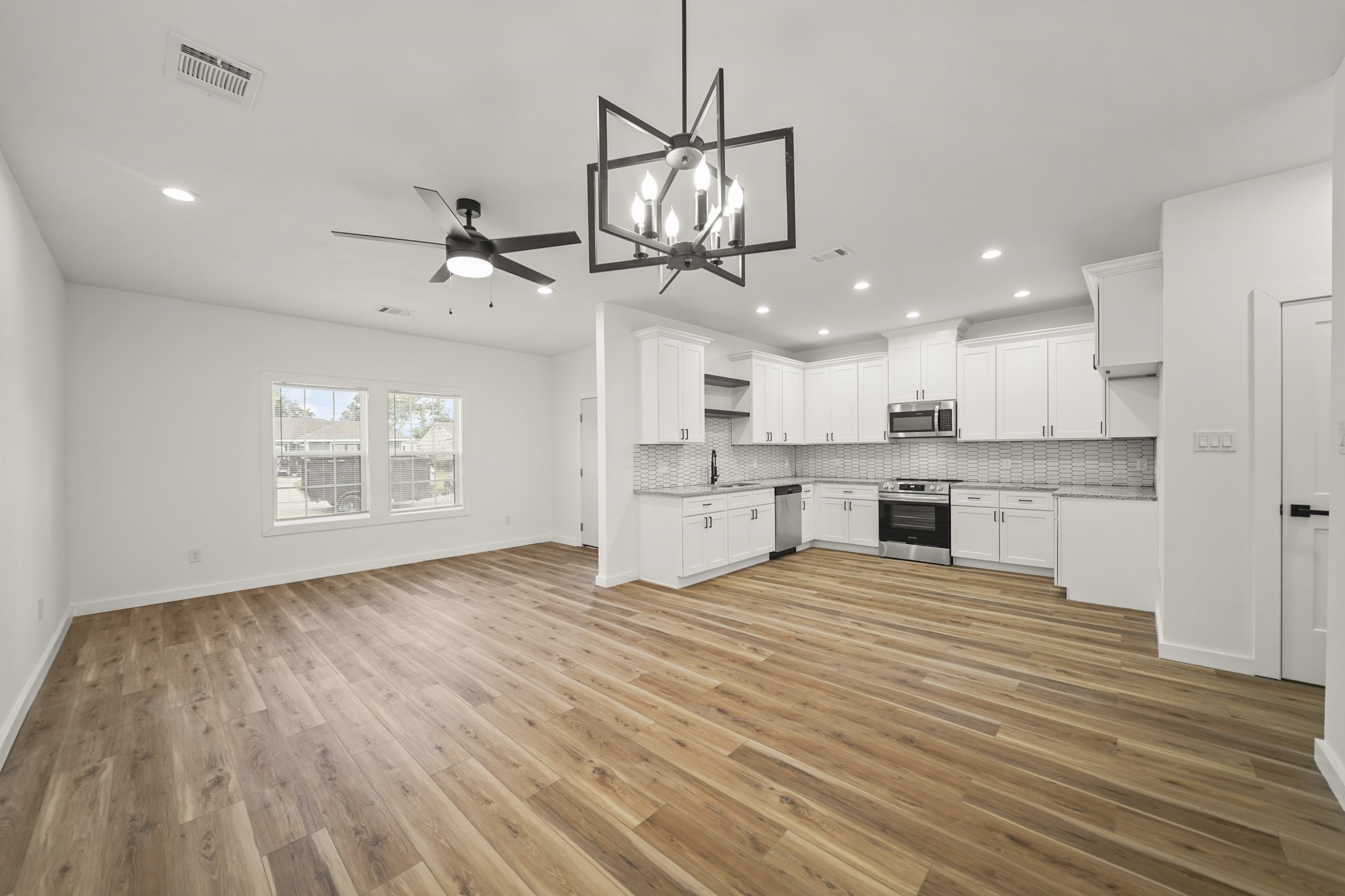 6206 Lyndhurst Drive, Unit AB Houston, TX 77087 - Photo 3 of 14 a view of a kitchen with microwave and cabinets