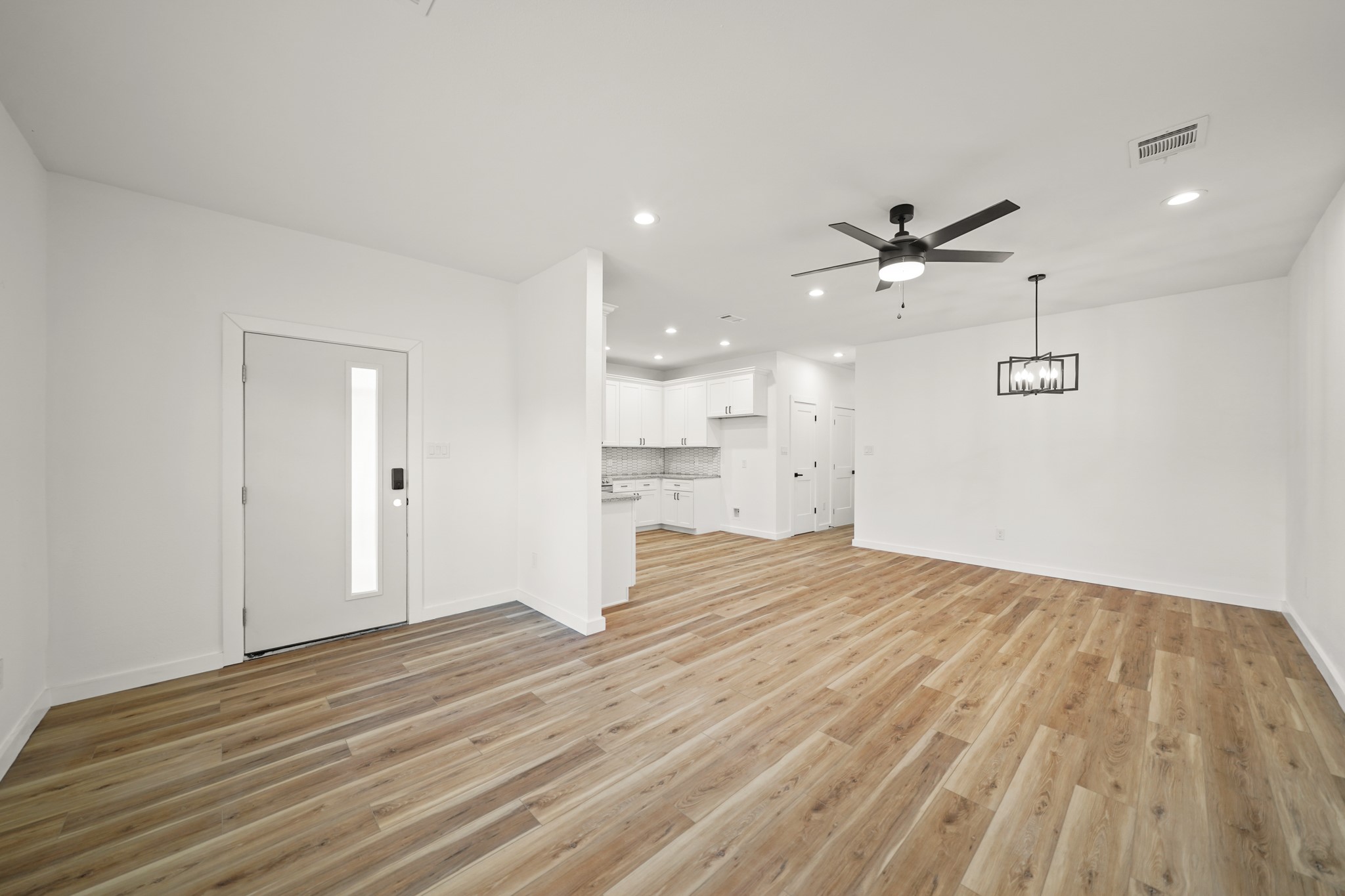 6206 Lyndhurst Drive, Unit AB Houston, TX 77087 - Photo 5 of 14 a view of a kitchen with a sink and wooden floor