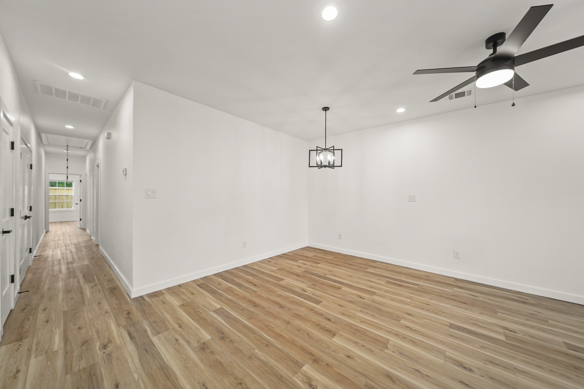 6206 Lyndhurst Drive, Unit AB Houston, TX 77087 - Photo 6 of 14 an empty room with wooden floor and windows
