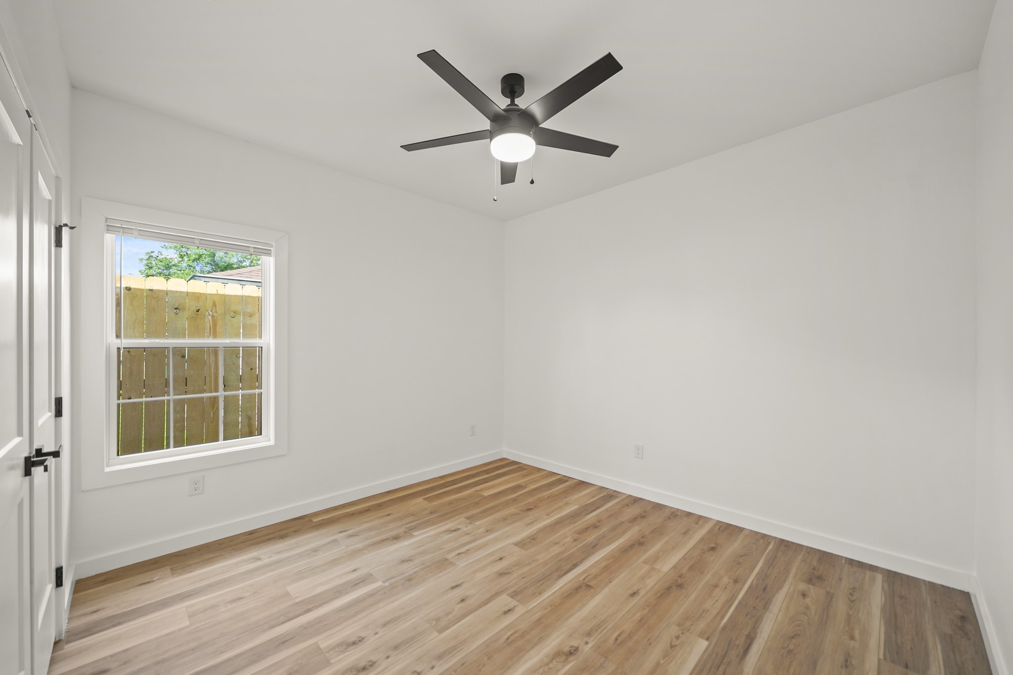 6206 Lyndhurst Drive, Unit AB Houston, TX 77087 - Photo 8 of 14 an empty room with wooden floor and windows