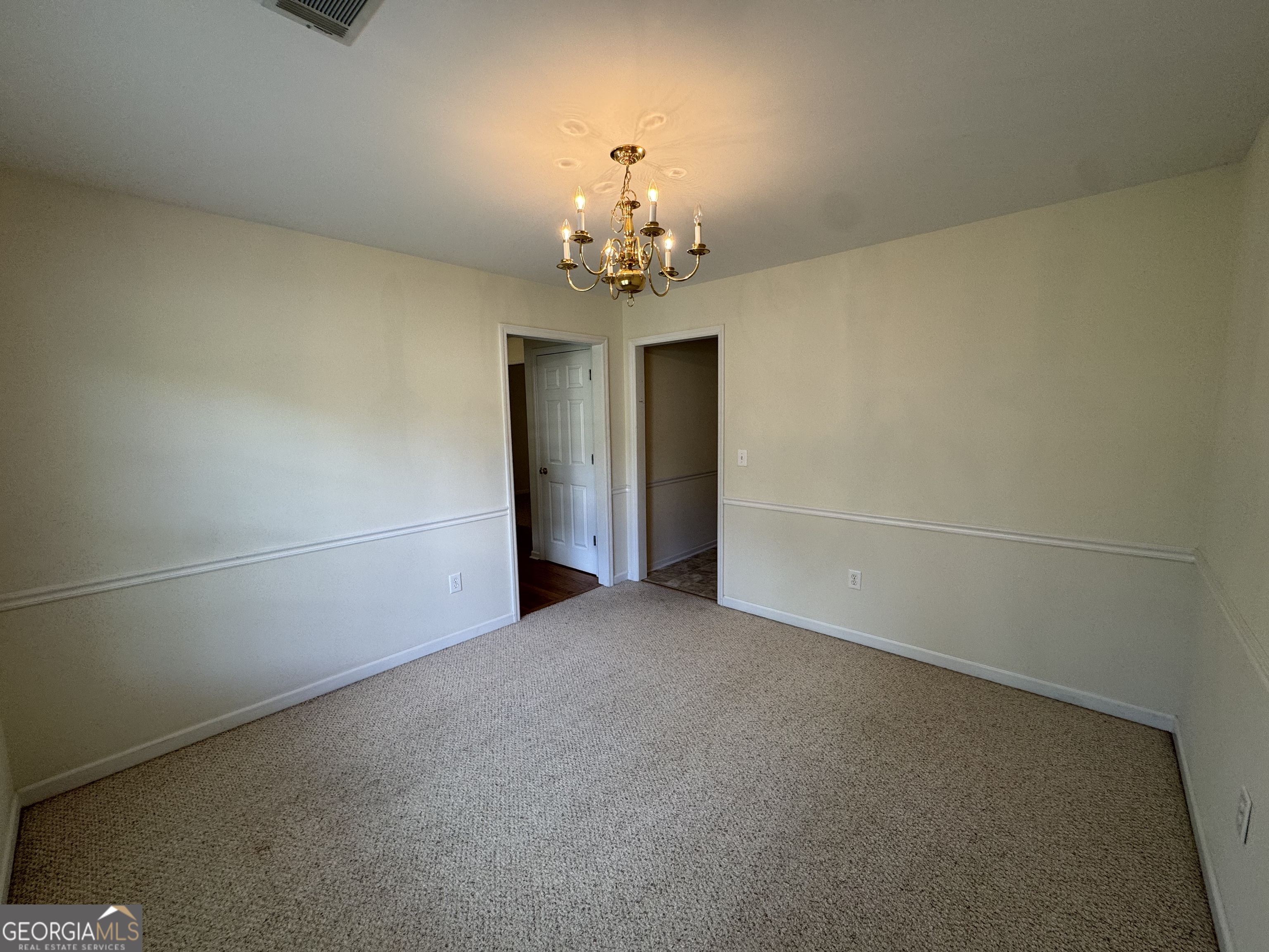 361 Brickleberry Ridge Athens, GA 30605 - Photo 12 of 23 wooden floor in an empty room with a chandelier