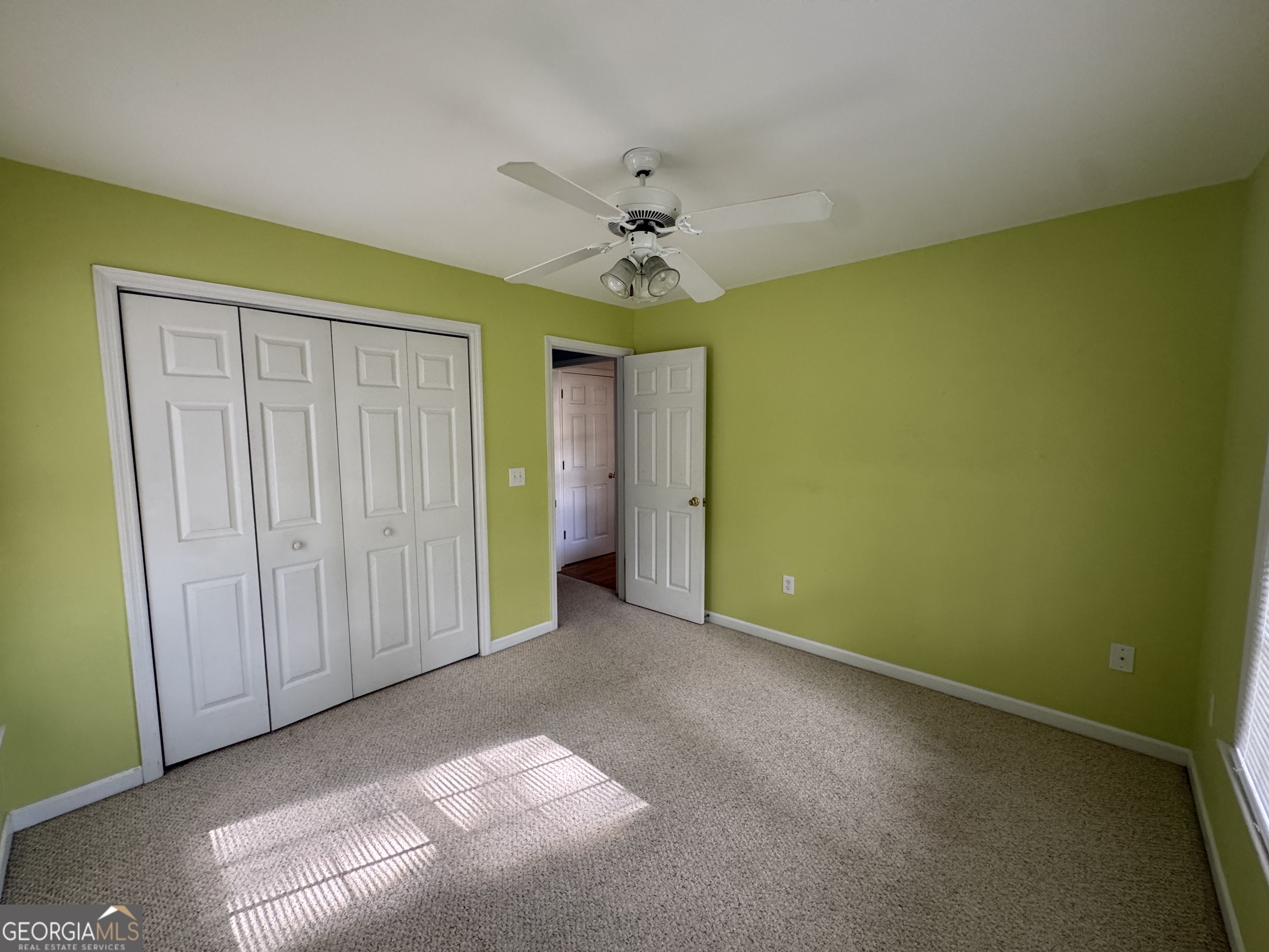361 Brickleberry Ridge Athens, GA 30605 - Photo 14 of 23 an empty room with a ceiling fan and a window
