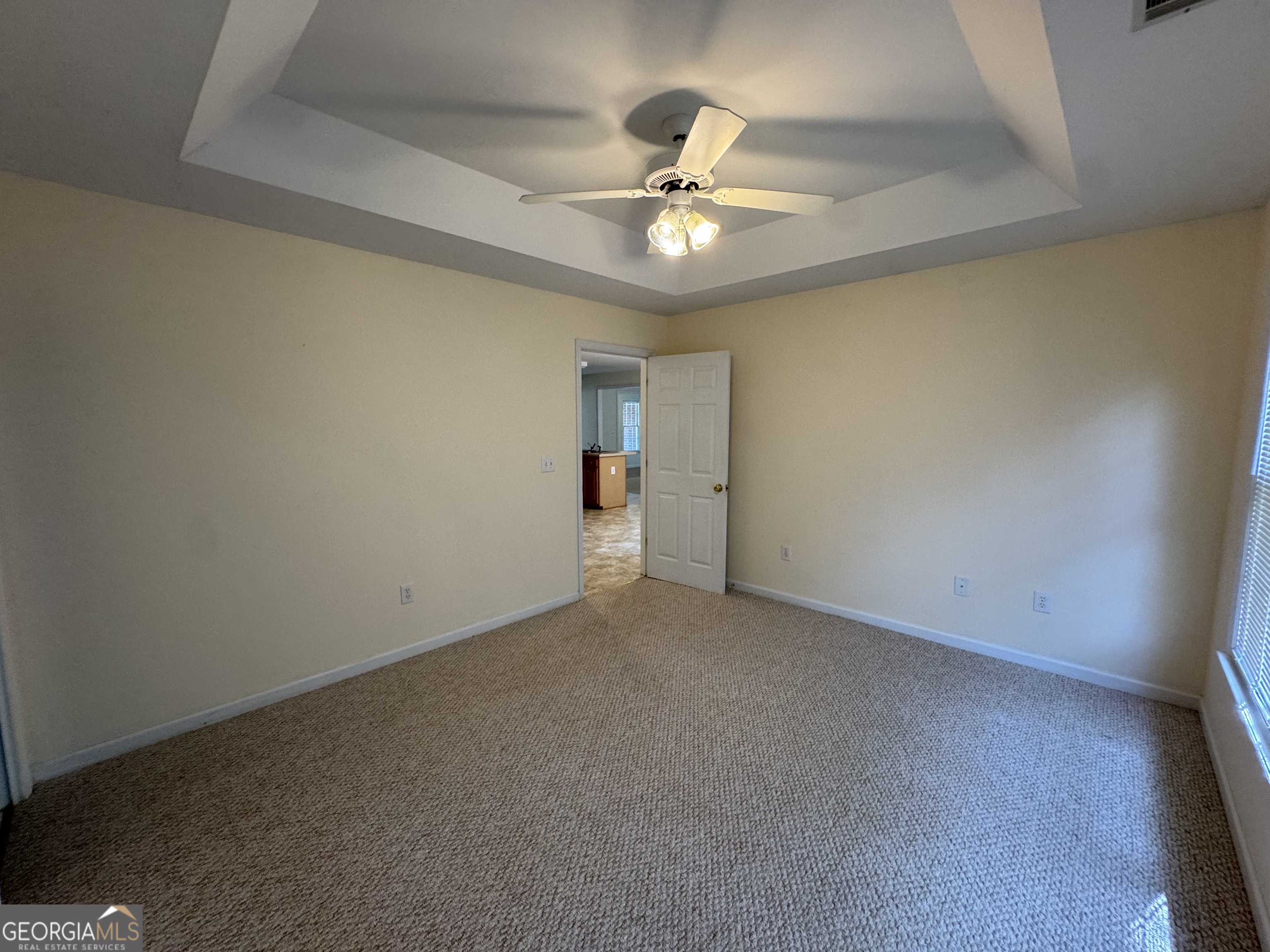361 Brickleberry Ridge Athens, GA 30605 - Photo 18 of 23 an empty room with a chandelier fan and windows