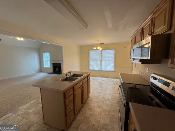 a kitchen with stainless steel appliances granite countertop a stove and a sink