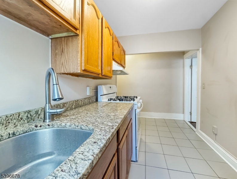 83 Jefferson Street, Unit B Phillipsburg, NJ 08865 - Photo 5 of 10 a kitchen with a sink a counter top space and cabinets