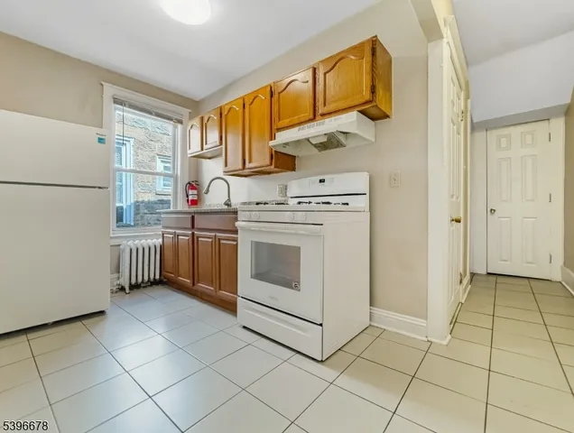 a kitchen with a stove a sink and a refrigerator