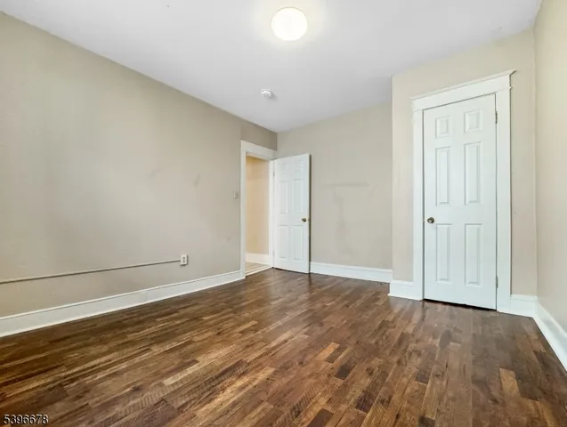 a view of an empty room and wooden floor