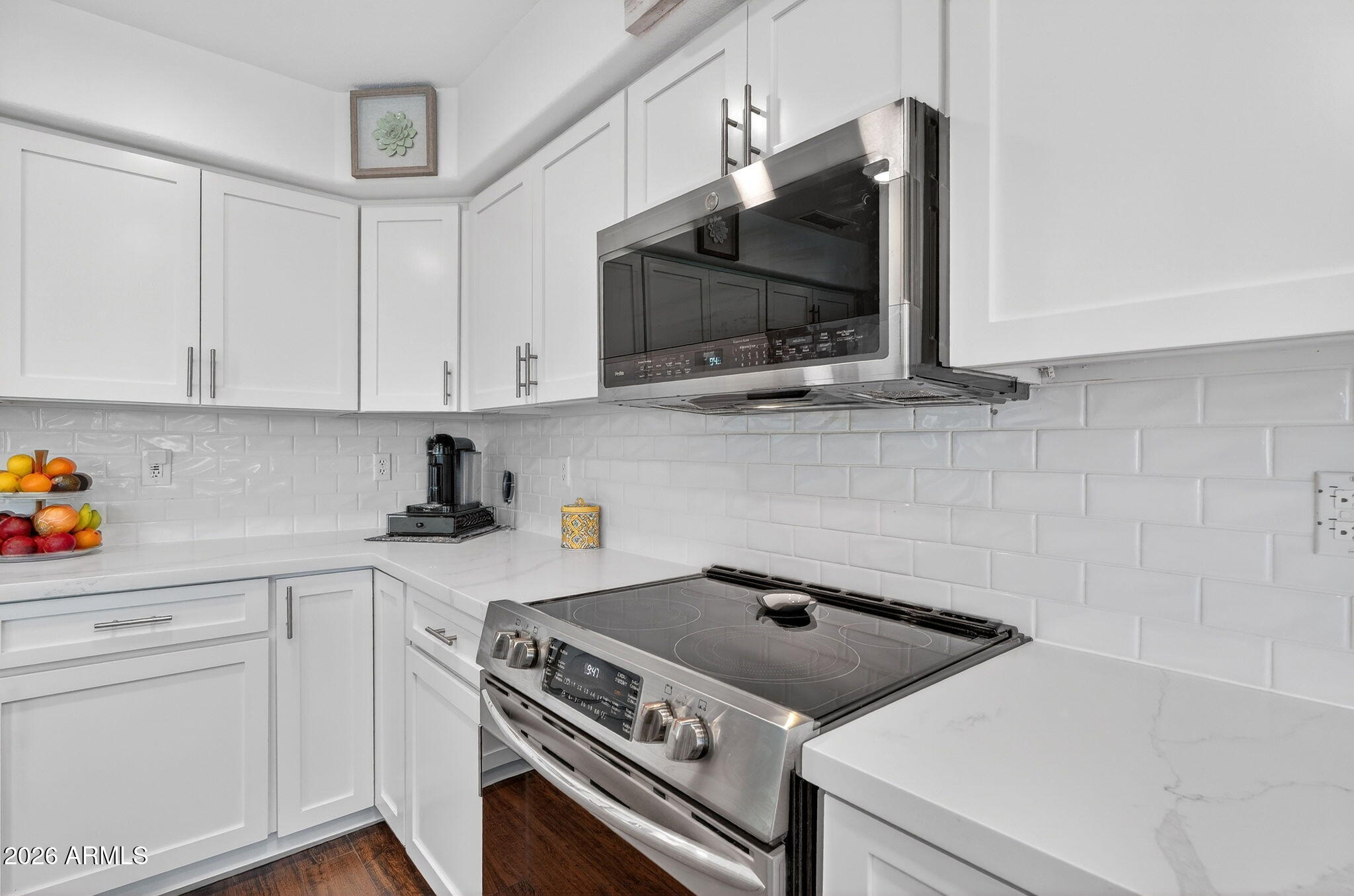3615 East Desert Willow Road Phoenix, AZ 85044 - Photo 12 of 65 a kitchen with a stove and a microwave