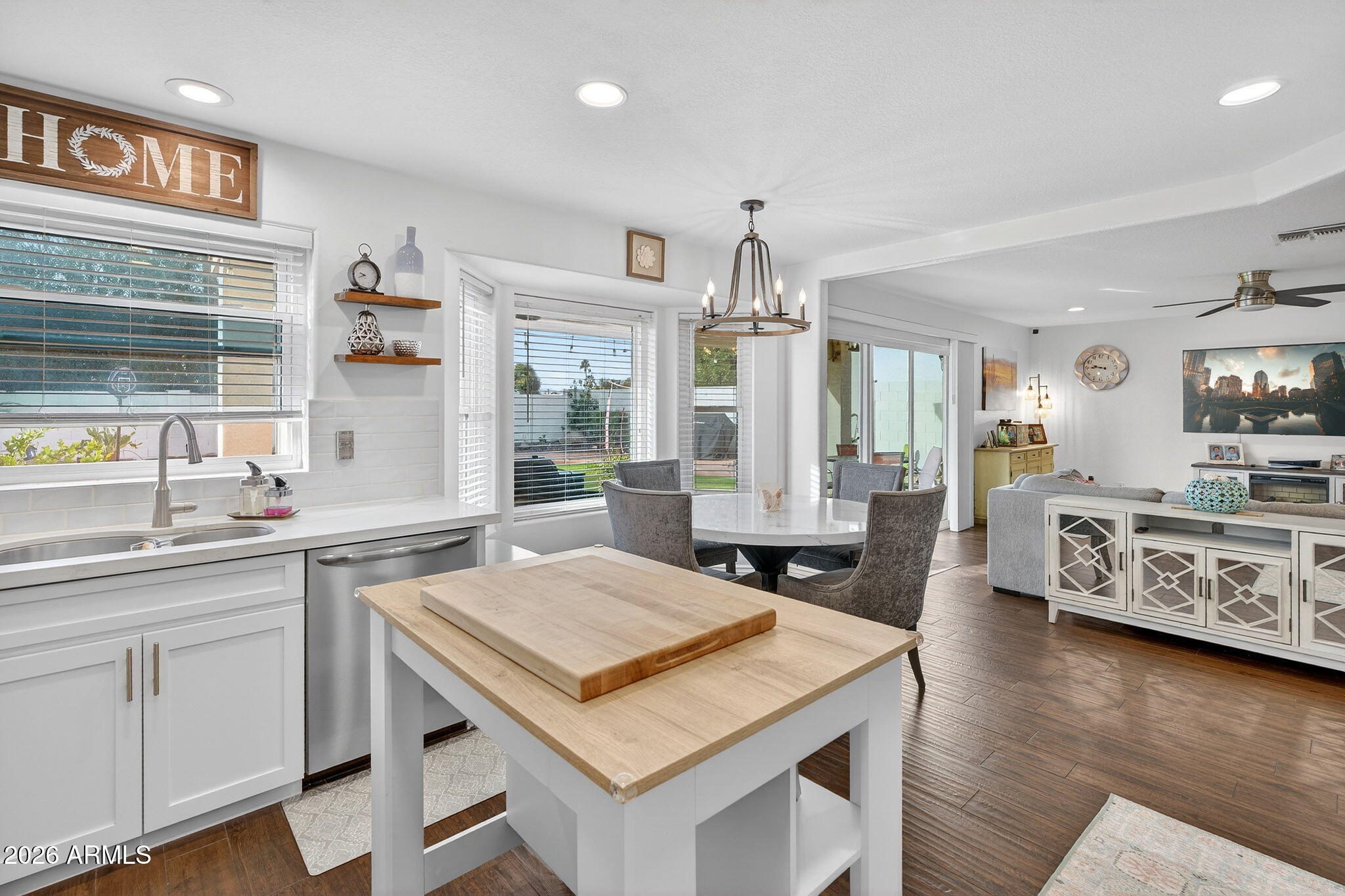 3615 East Desert Willow Road Phoenix, AZ 85044 - Photo 13 of 65 a kitchen with a stove a sink dishwasher a refrigerator and white cabinets with wooden floor