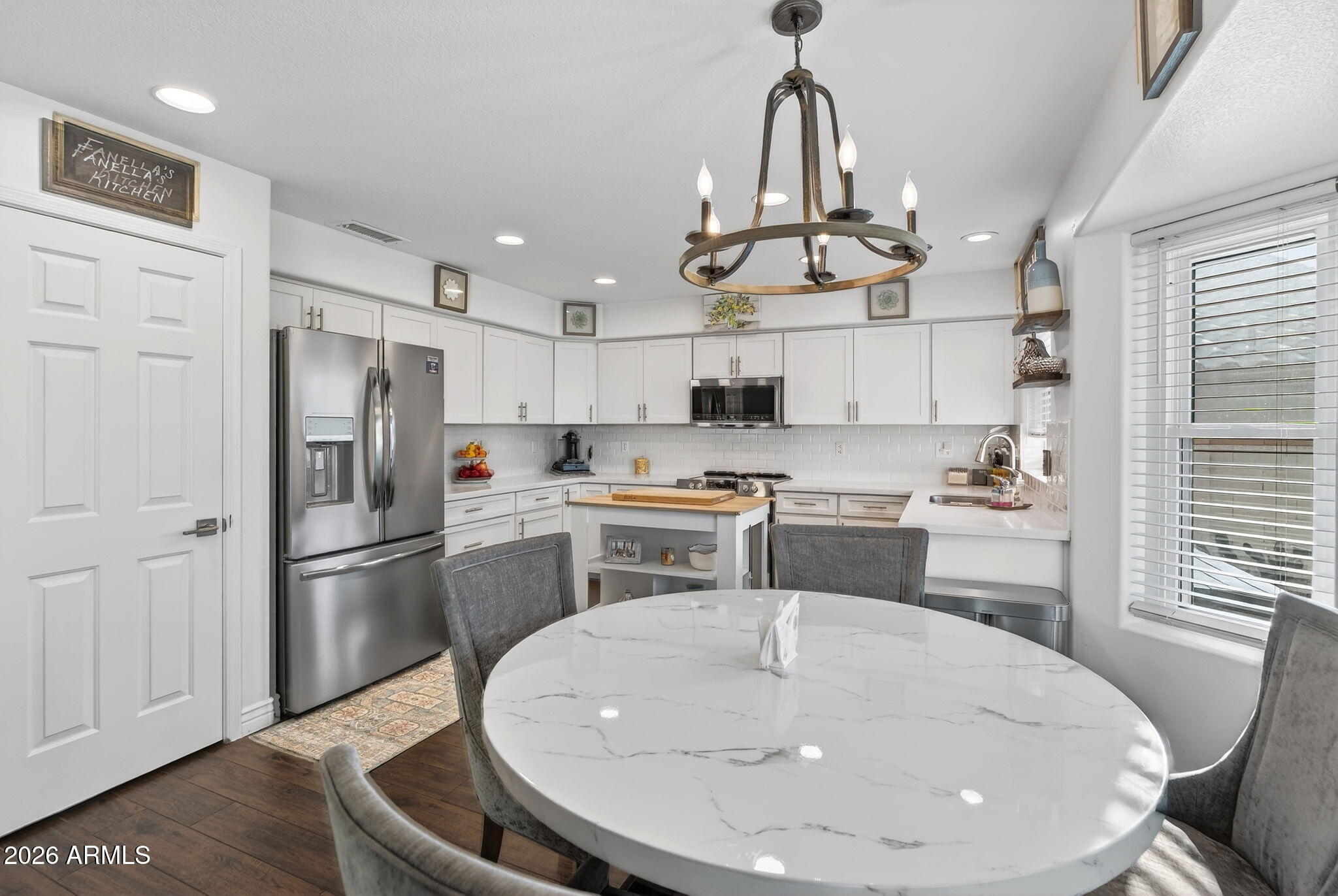 3615 East Desert Willow Road Phoenix, AZ 85044 - Photo 16 of 65 a kitchen with stainless steel appliances granite countertop a sink a stove a refrigerator cabinets and a dining table