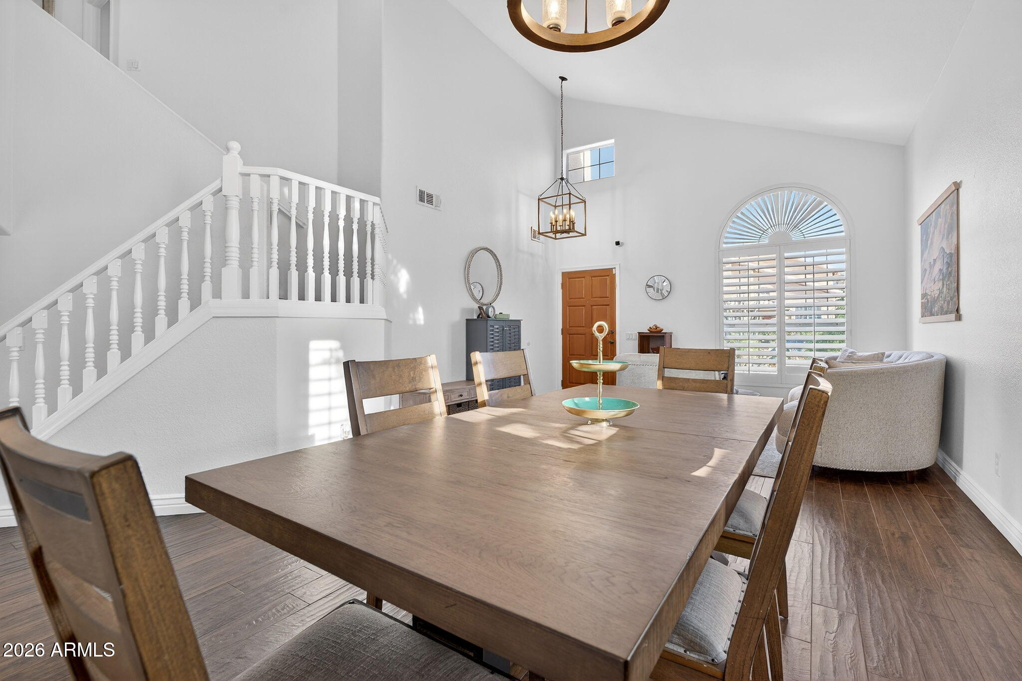 3615 East Desert Willow Road Phoenix, AZ 85044 - Photo 21 of 65 a dining room with furniture a window and wooden floor