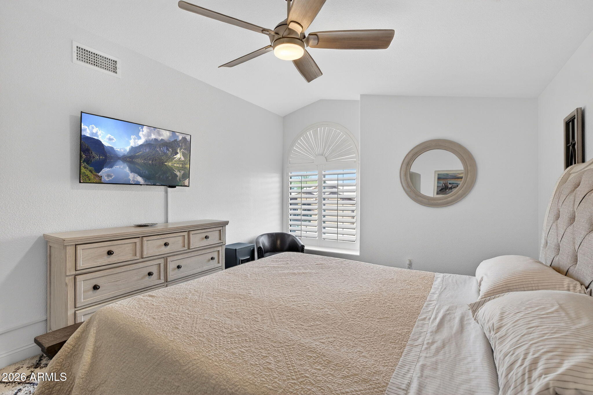 3615 East Desert Willow Road Phoenix, AZ 85044 - Photo 26 of 65 a bedroom with a bed a mirror and a large window