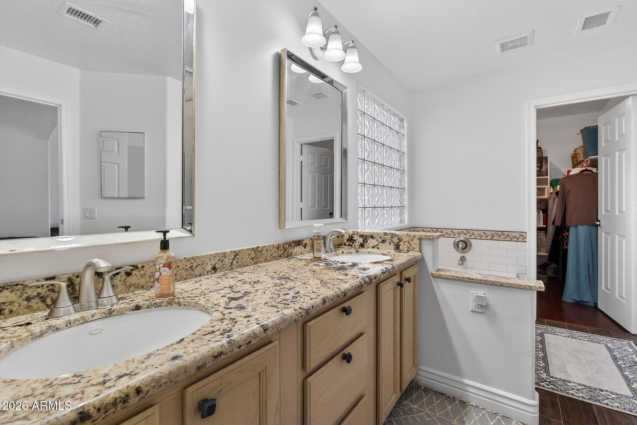 3615 East Desert Willow Road Phoenix, AZ 85044 - Photo 29 of 65 a bathroom with a granite countertop sink and a mirror