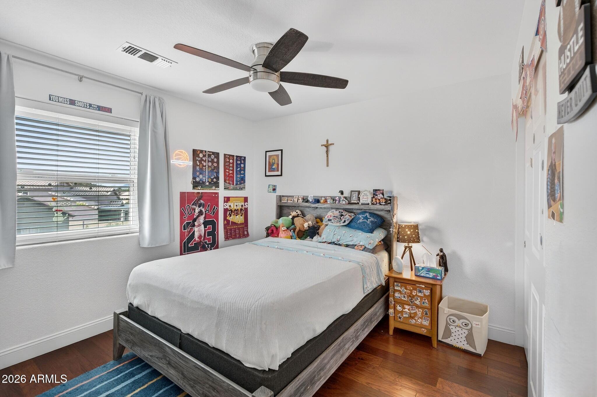 3615 East Desert Willow Road Phoenix, AZ 85044 - Photo 31 of 65 a bedroom with a bed and a window