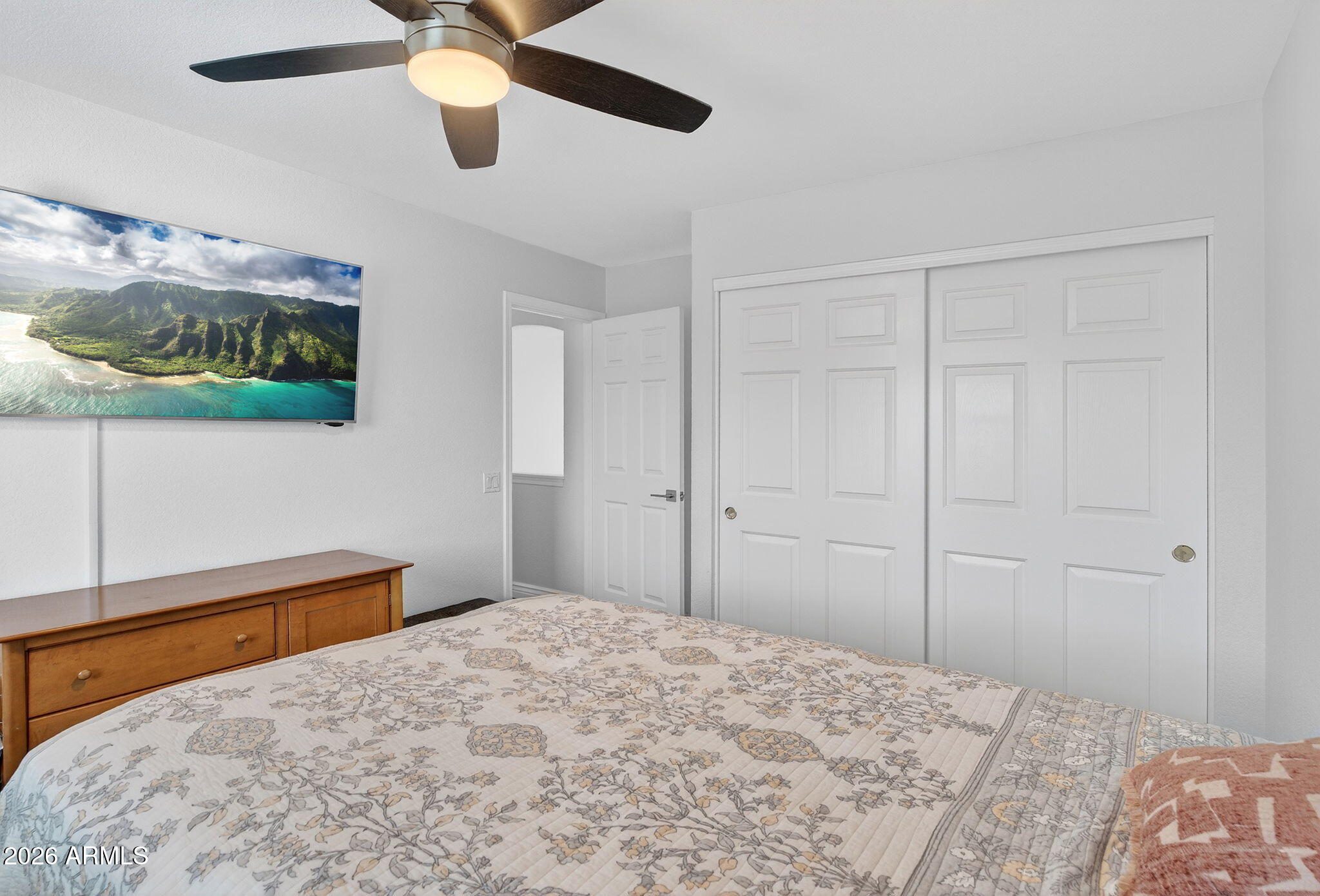 3615 East Desert Willow Road Phoenix, AZ 85044 - Photo 34 of 65 a bedroom with a bed and a flat screen tv