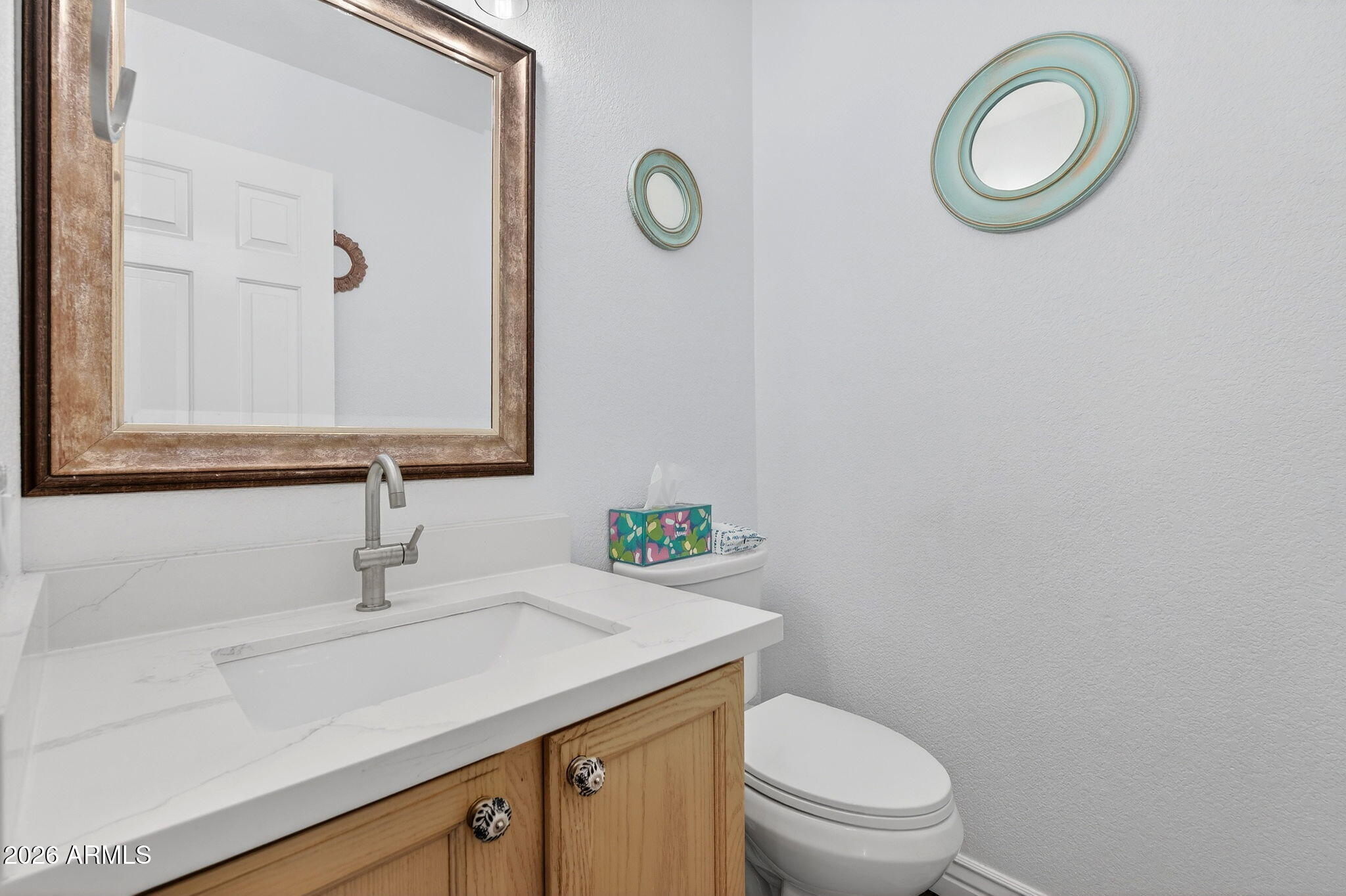 3615 East Desert Willow Road Phoenix, AZ 85044 - Photo 37 of 65 a bathroom with a granite countertop toilet sink and mirror