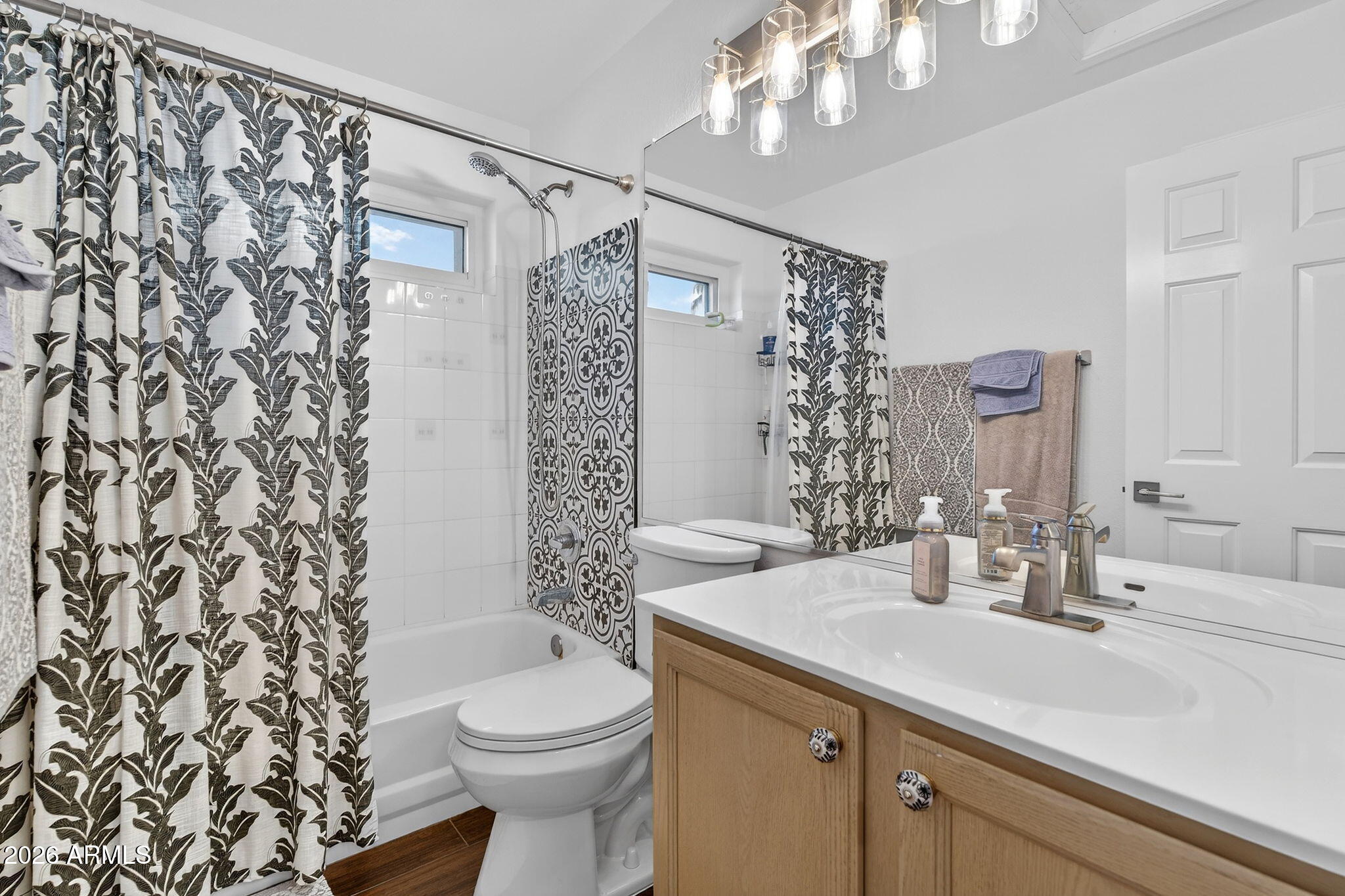 3615 East Desert Willow Road Phoenix, AZ 85044 - Photo 38 of 65 a bathroom with a sink a toilet and shower