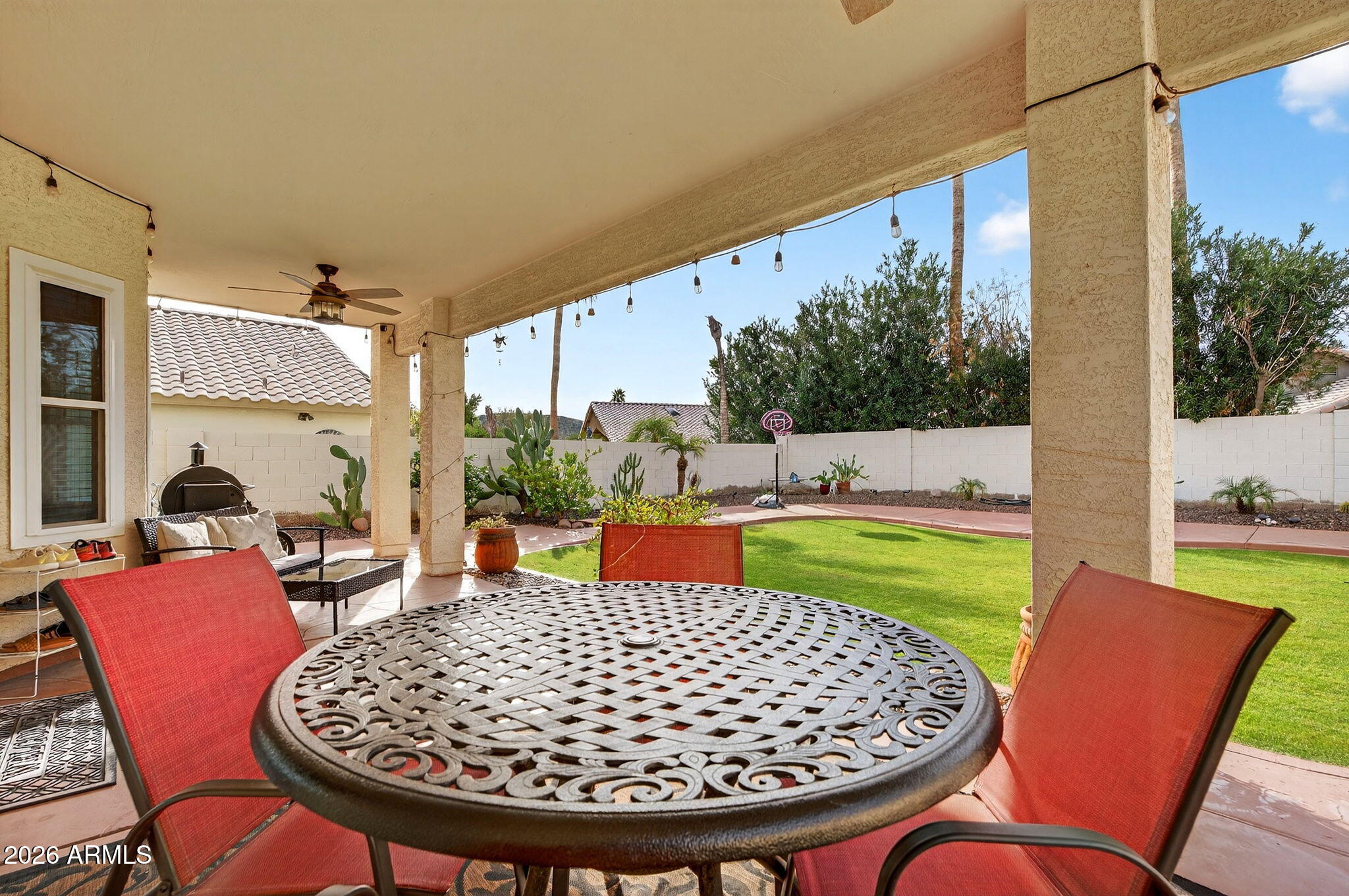 3615 East Desert Willow Road Phoenix, AZ 85044 - Photo 45 of 65 a view of an outdoor dining space with a table and chairs