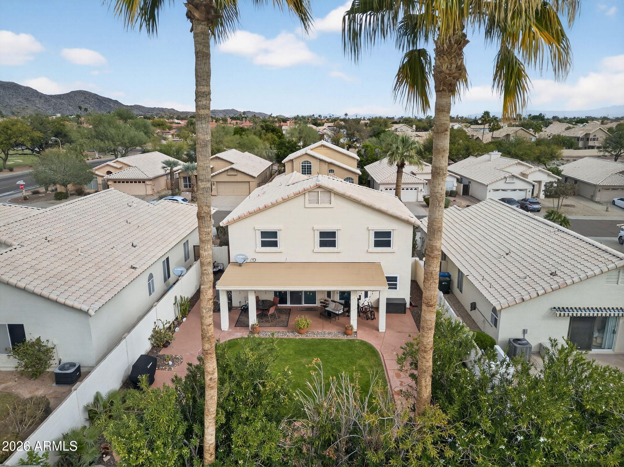 3615 East Desert Willow Road Phoenix, AZ 85044 - Photo 54 of 65 an aerial view of multiple houses with a yard