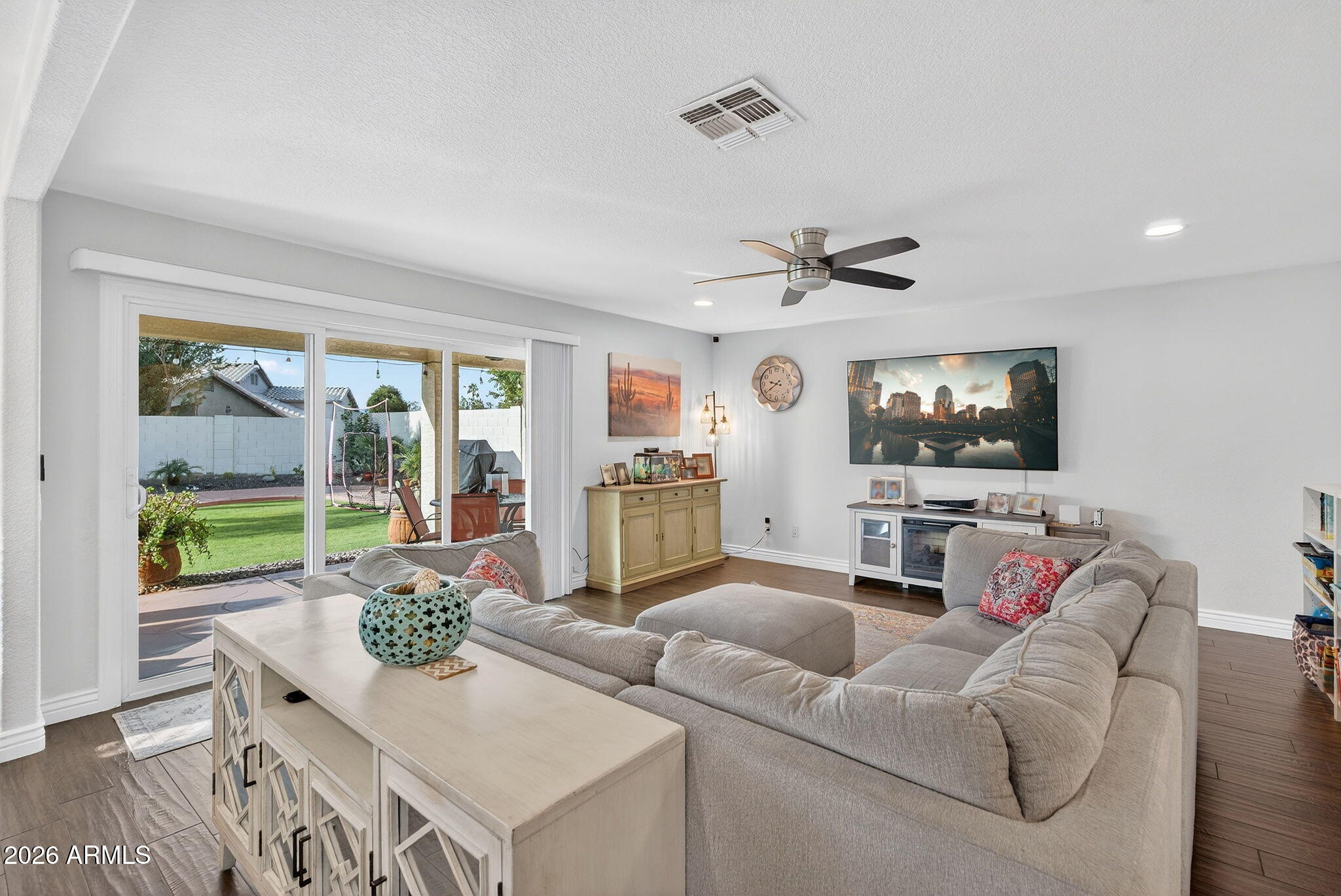 3615 East Desert Willow Road Phoenix, AZ 85044 - Photo 6 of 65 a living room with furniture and a flat screen tv