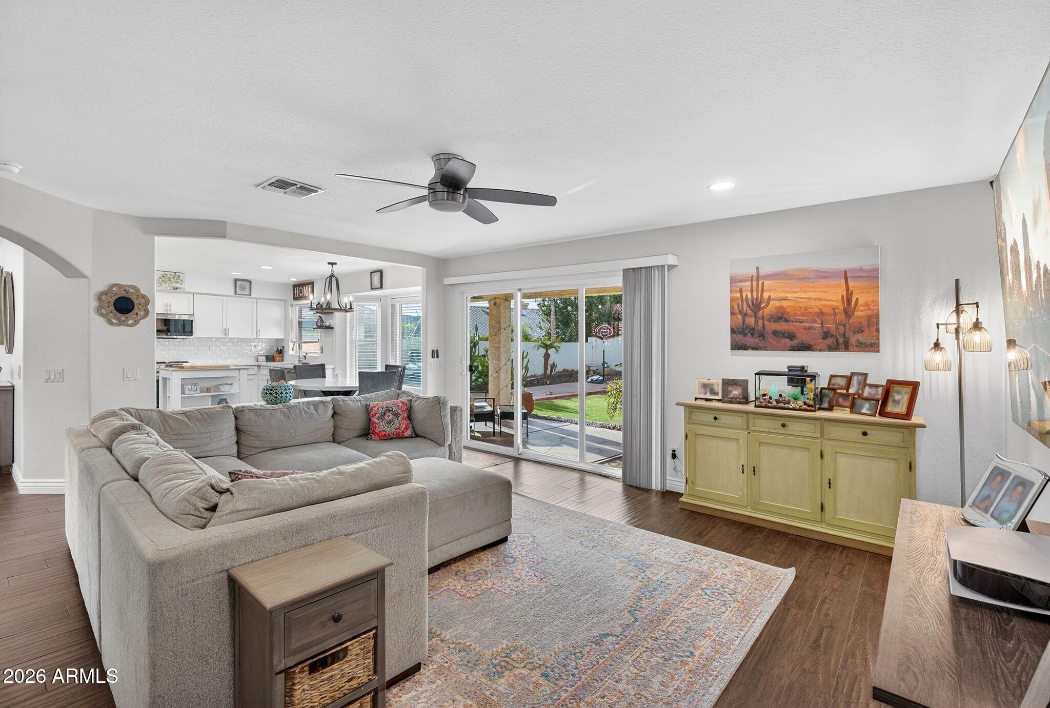 3615 East Desert Willow Road Phoenix, AZ 85044 - Photo 7 of 65 a living room with furniture and a kitchen