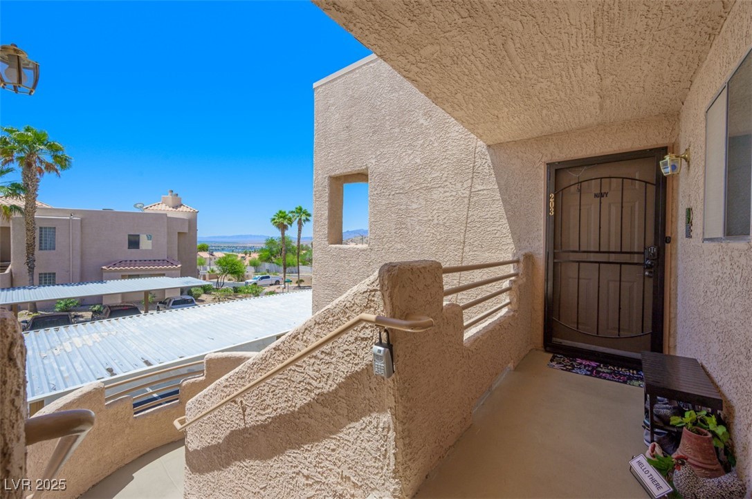 2240 Highpointe Drive, Unit 203 Laughlin, NV 89029 - Photo 11 of 38 View of exterior entry featuring a balcony and stucco siding