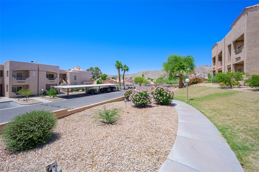 2240 Highpointe Drive, Unit 203 Laughlin, NV 89029 - Photo 2 of 38 View of home's community featuring a residential view, covered parking, a lawn, and a mountain view