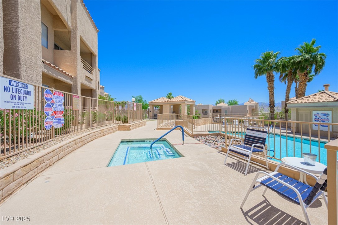 2240 Highpointe Drive, Unit 203 Laughlin, NV 89029 - Photo 8 of 38 Community pool featuring fence, a community hot tub, and a patio area