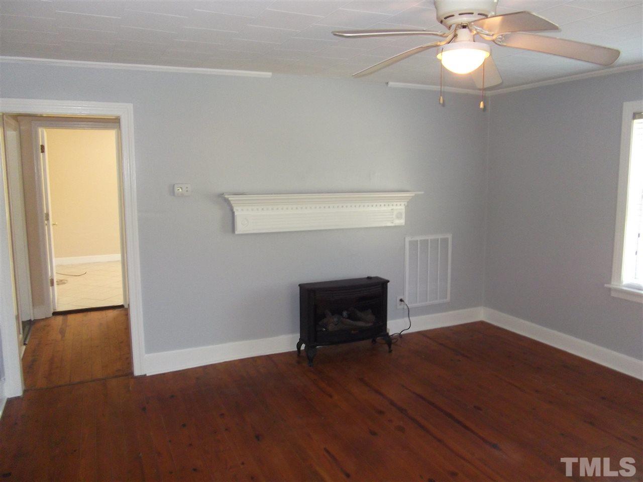 1102 Stallings Road Durham, NC 27703 - Photo 5 of 15 a view of empty room with wooden floor and fan