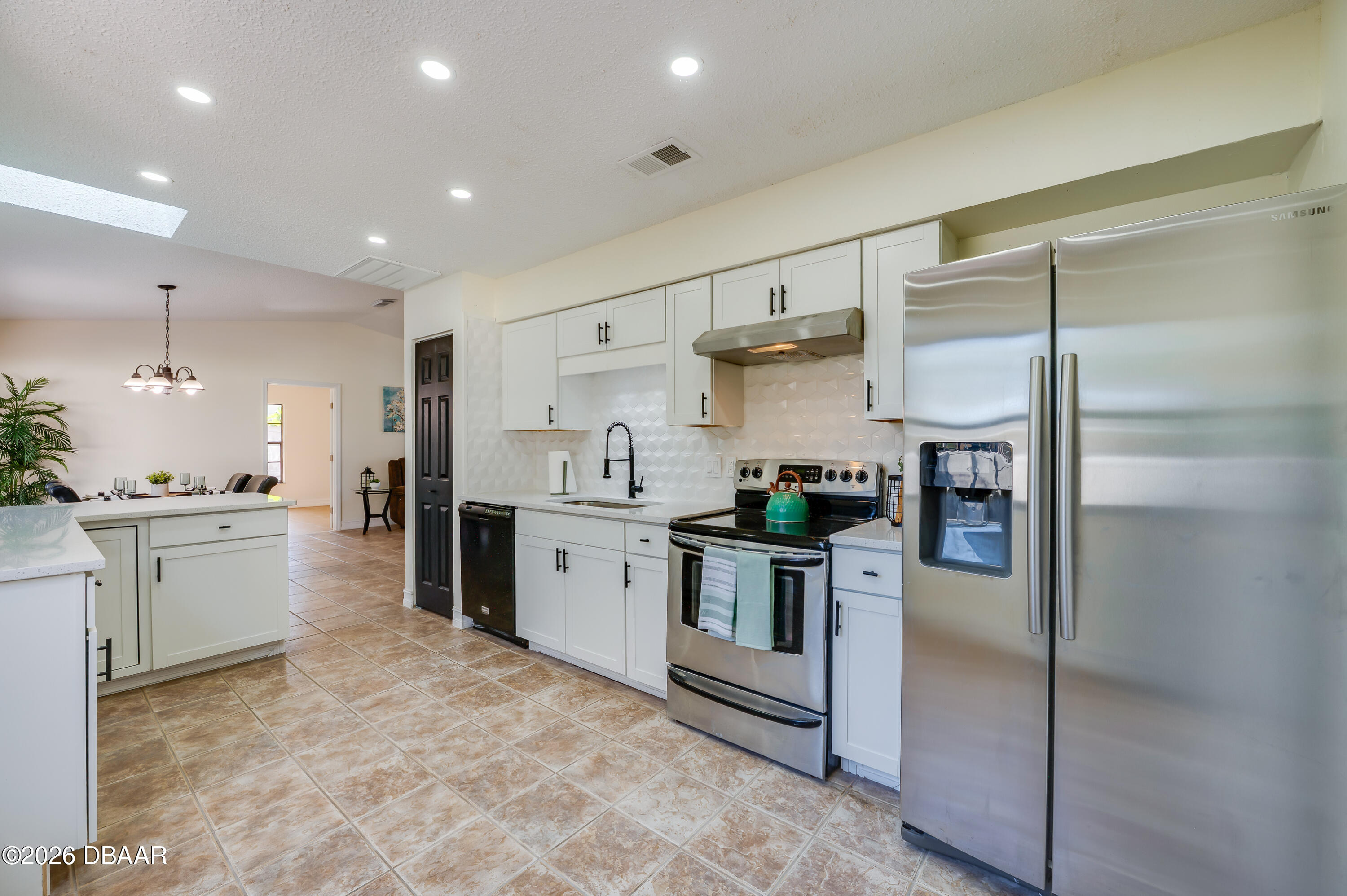 2425 Royal Palm Drive Edgewater, FL 32141 - Photo 13 of 41 a kitchen with refrigerator and cabinets