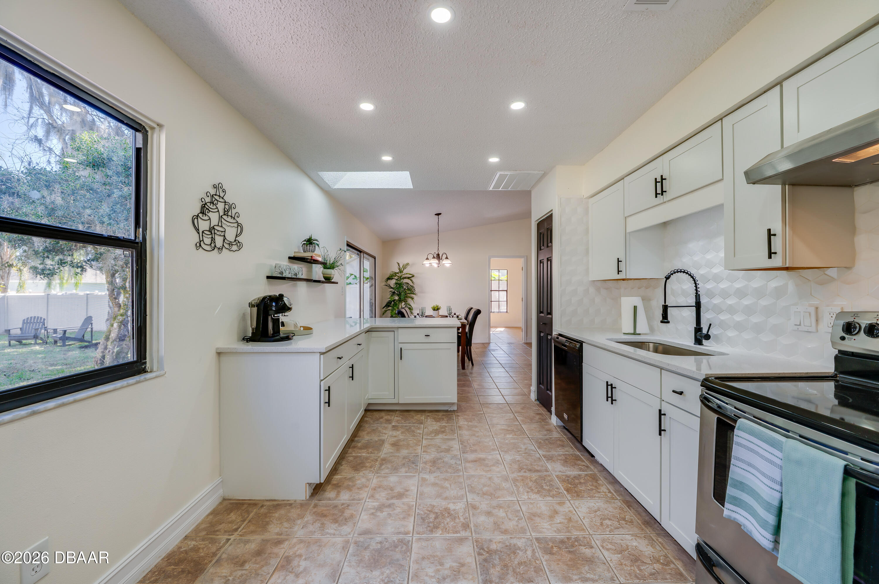 2425 Royal Palm Drive Edgewater, FL 32141 - Photo 14 of 41 a large kitchen with stainless steel appliances a sink stove and cabinets