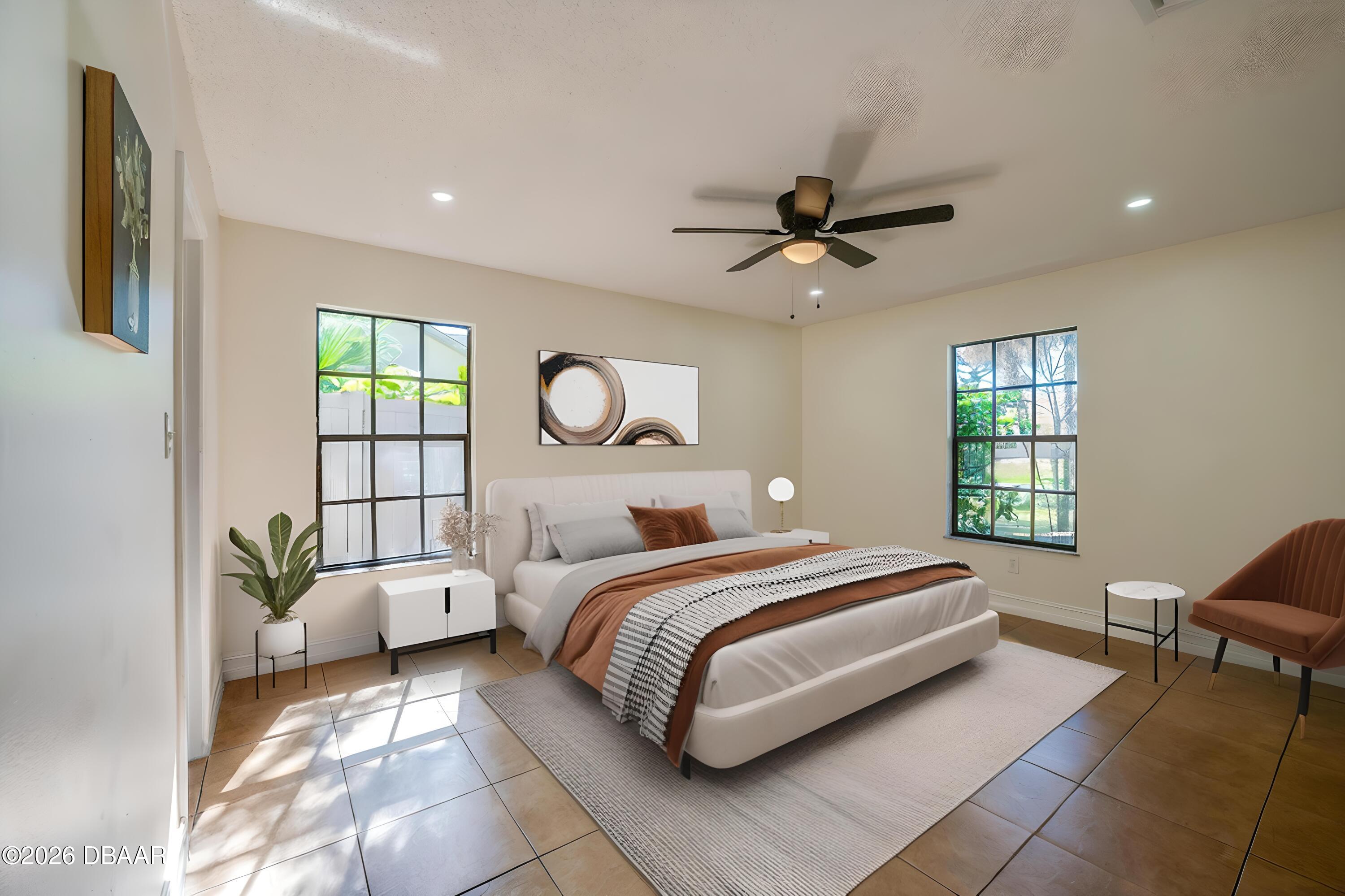 2425 Royal Palm Drive Edgewater, FL 32141 - Photo 17 of 41 a bed room with a bed and a chandelier