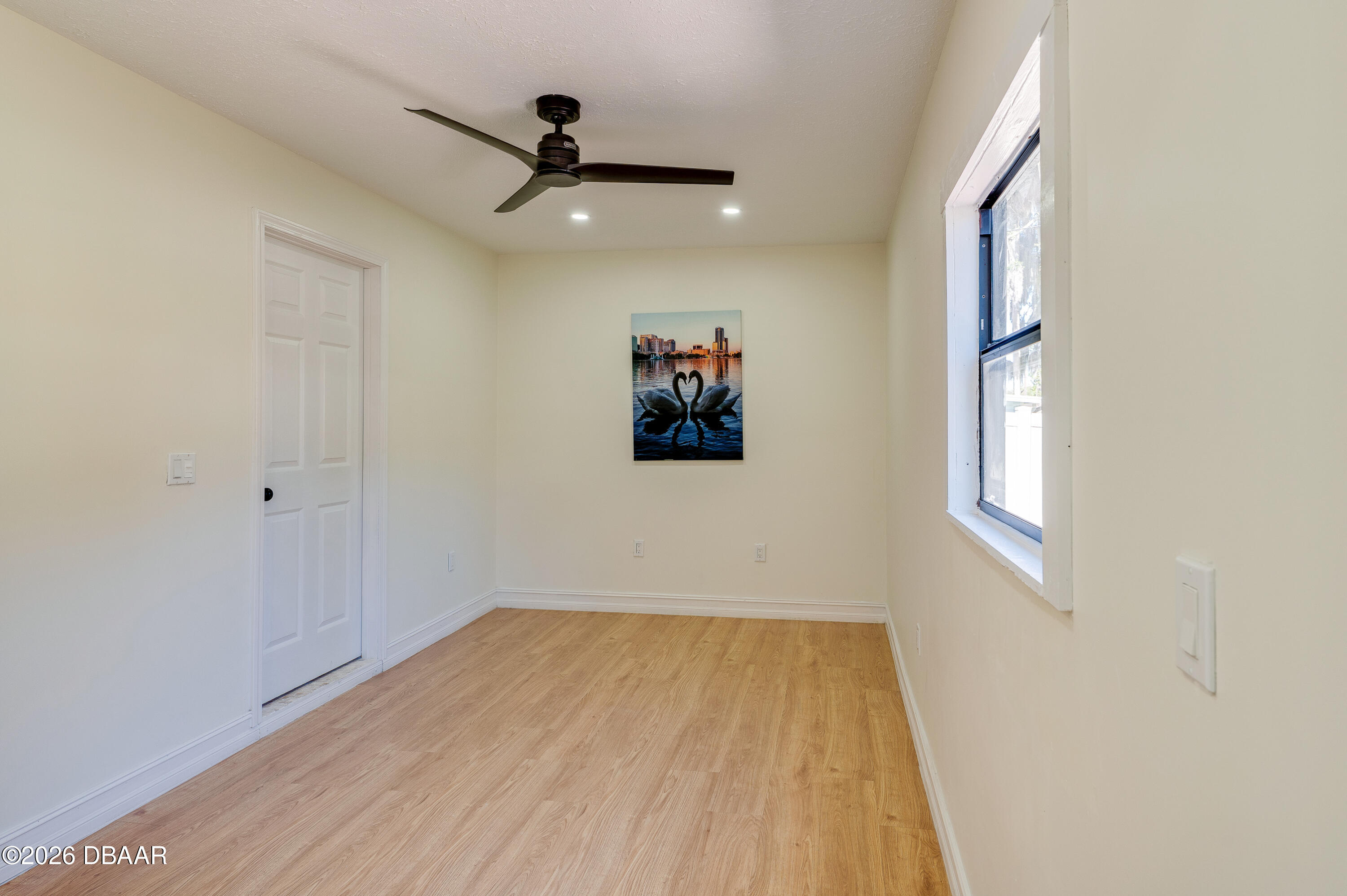 2425 Royal Palm Drive Edgewater, FL 32141 - Photo 27 of 41 a view of a hallway with wooden floor and a ceiling fan