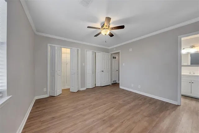a view of a room with wooden floor and ceiling fan