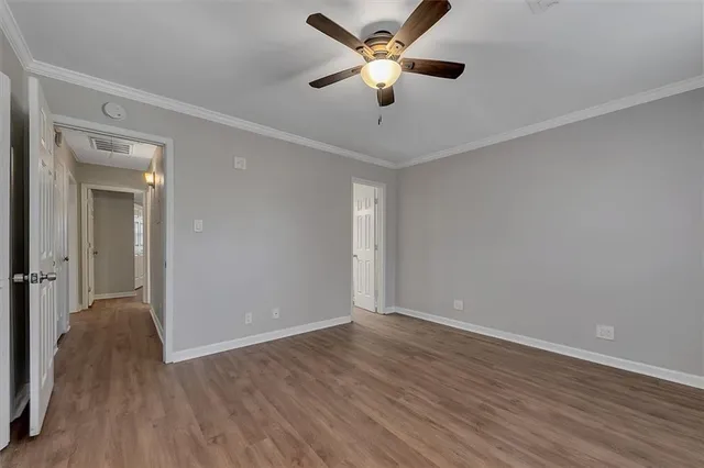 a view of an empty room with wooden floor