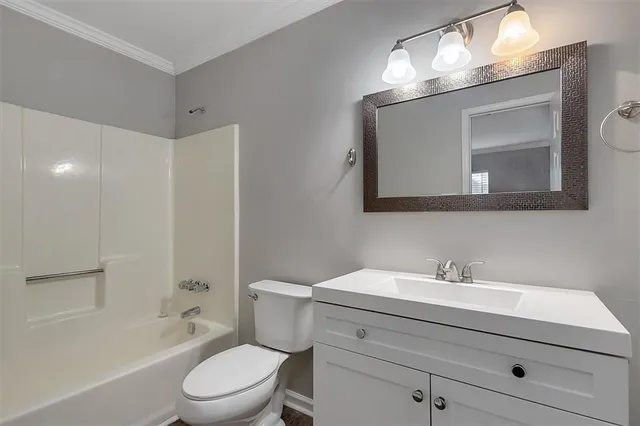 a bathroom with a toilet a sink a bathtub and a mirror