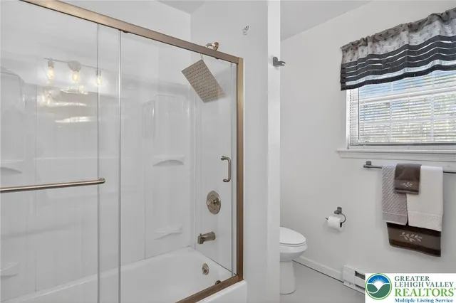 a bedroom with a bed and a ceiling fan