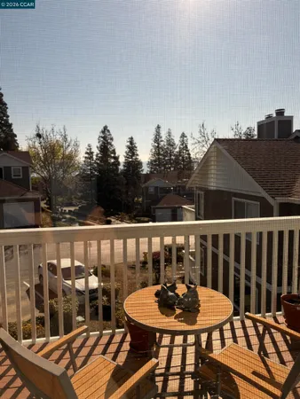 a balcony with table and chairs