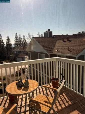 a balcony with table and chairs
