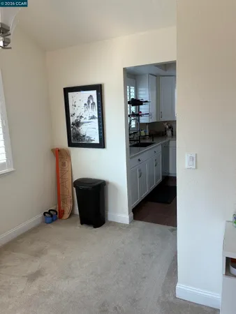 a view of kitchen with refrigerator and window