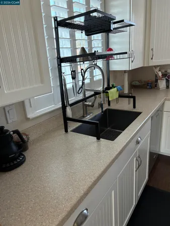 a kitchen with stainless steel appliances granite countertop a sink and cabinets