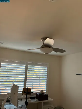 a bed sitting in a bedroom next to a window