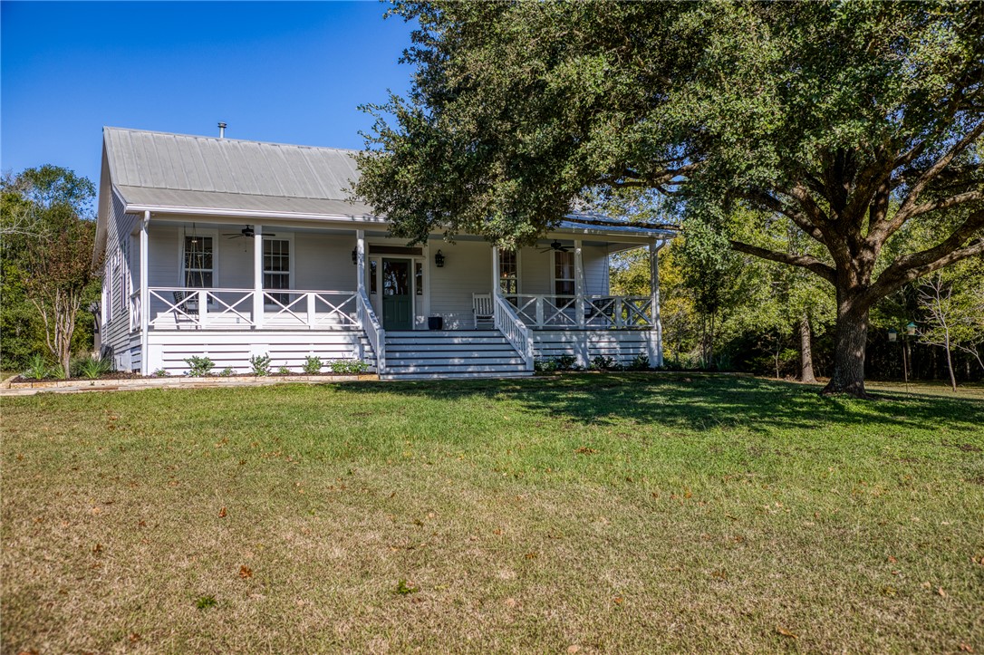 a front view of house with yard and outdoor seating