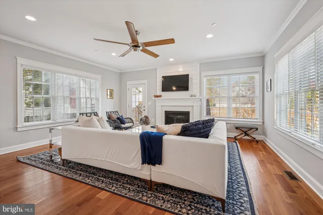 a living room with furniture fireplace and a large window
